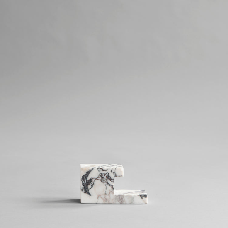 A 101 COPENHAGEN BRICK CANDLE HOLDER sitting on top of a grey surface.