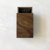 A handmade WOODEN MATCHBOX from HOUSE OF GOOD containing a set of black pencils.