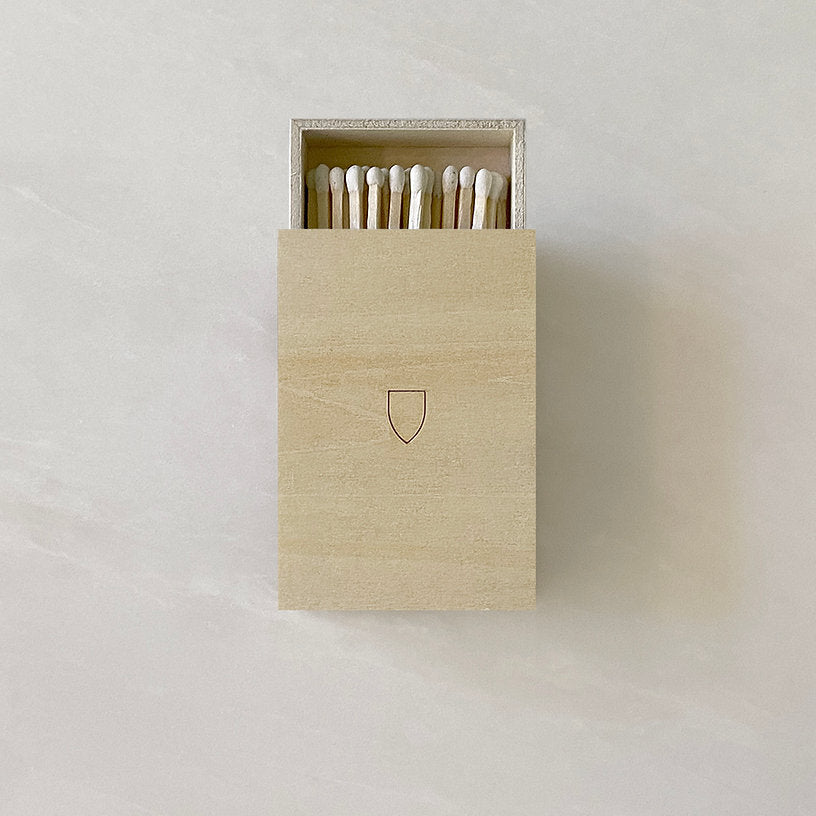 Handmade WOODEN MATCHBOXES from HOUSE OF GOOD shield, placed on a white surface.