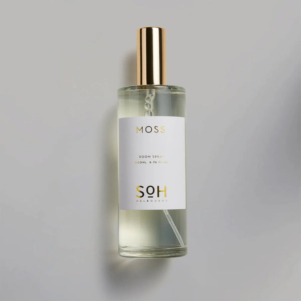 A bottle of MOSS ROOM SPRAY from SOH MELBOURNE with a gold label on a white background.