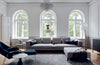 A white living room with arched windows designed by COZY's FUNKTIO.