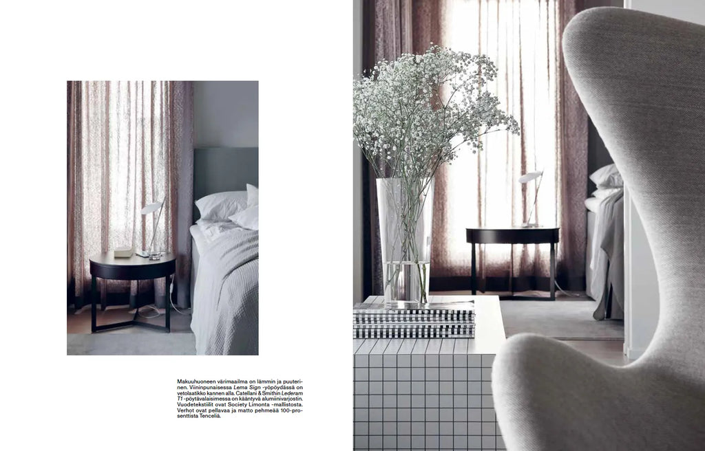 An image of a bedroom with a COZY FUNKTIO grey chair and a vase.