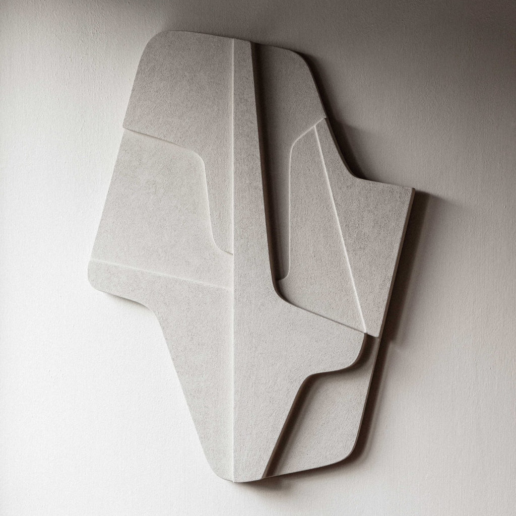 A limited edition white piece of art, the Atelier Plateau 02:59 AM Relief, hangs gracefully on the wall of a room. Crafted with eco-friendly plaster, this stunning artwork adds a touch.
