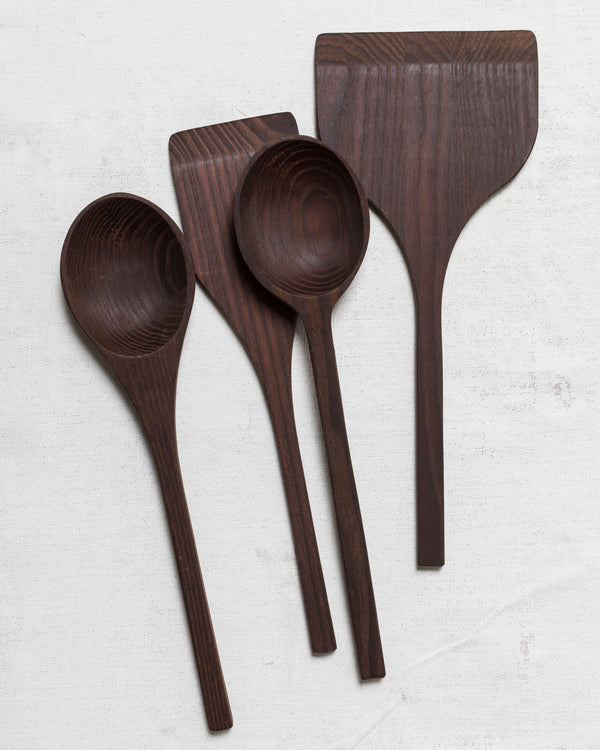 Three Pure Utensils wooden measuring spoons made from carbonized ash wood by Pascale Naessens on a white surface. (Brand Name: Serax)