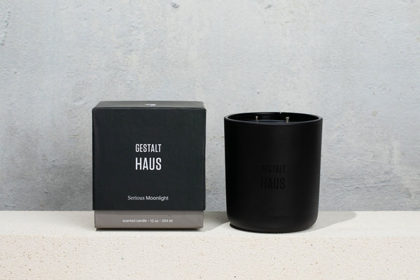 A black GESTALT HAUS Serious Moonlight Candle with a box next to it.