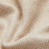 A close up of a SIBAST ALPACA HERRINGBONE THROW blanket featuring Gestalt Haus.