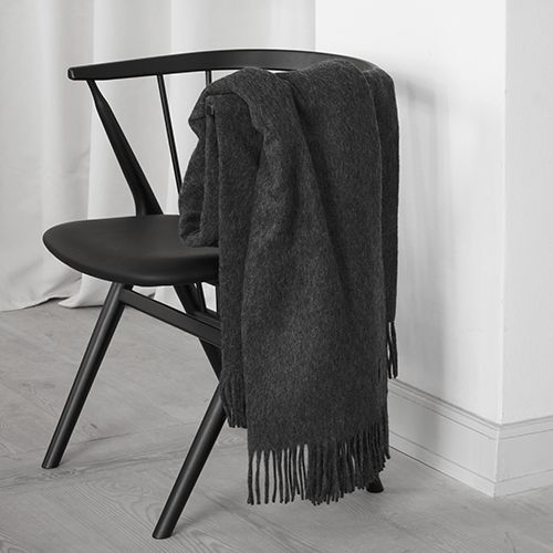 A black SIBAST chair with a black ALPACA THROW blanket on it, found at Gestalt Haus.