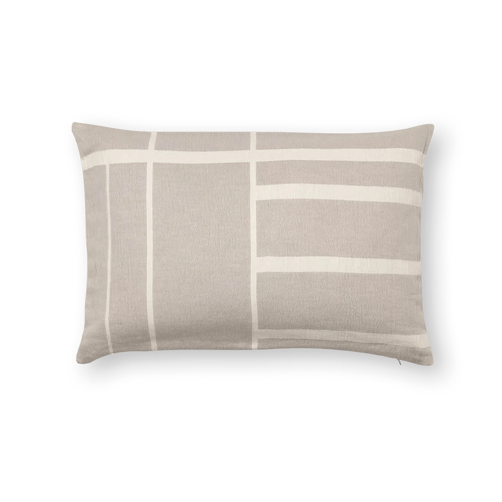 An ARCHITECTURE CUSHION with a grey and white stripe on it from KRISTINA DAM STUDIO, inspired by Gestalt Haus.