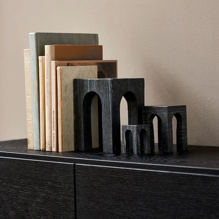 A set of Gestalt Haus MARBLE SCULPTURES on a black shelf by GEJST.