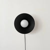 An ARUNDEL ORB SURFACE MOUNT wall lamp from IN COMMON WITH, in white, adorns the wall.