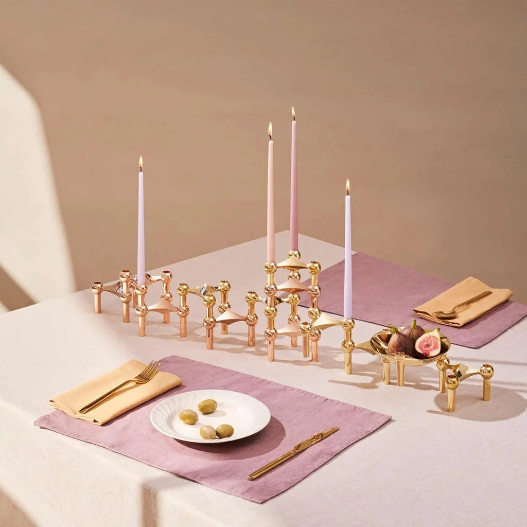 A table setting with candles, plates, and STOFF NAGEL BOWLS at Gestalt Haus.
