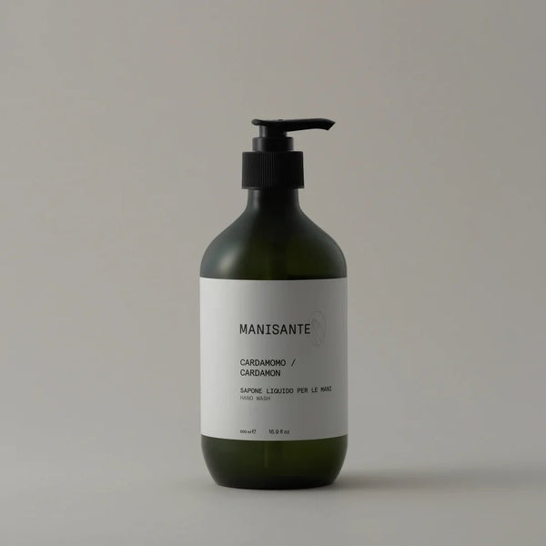 A bottle of MANISANTE CARDAMON HAND WASH on a white background featuring Gestalt Haus logo.