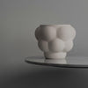 A Louise Roe Ceramic Balloon Bowl 05 sits on a table next to a gray wall in the Gestalt Haus.