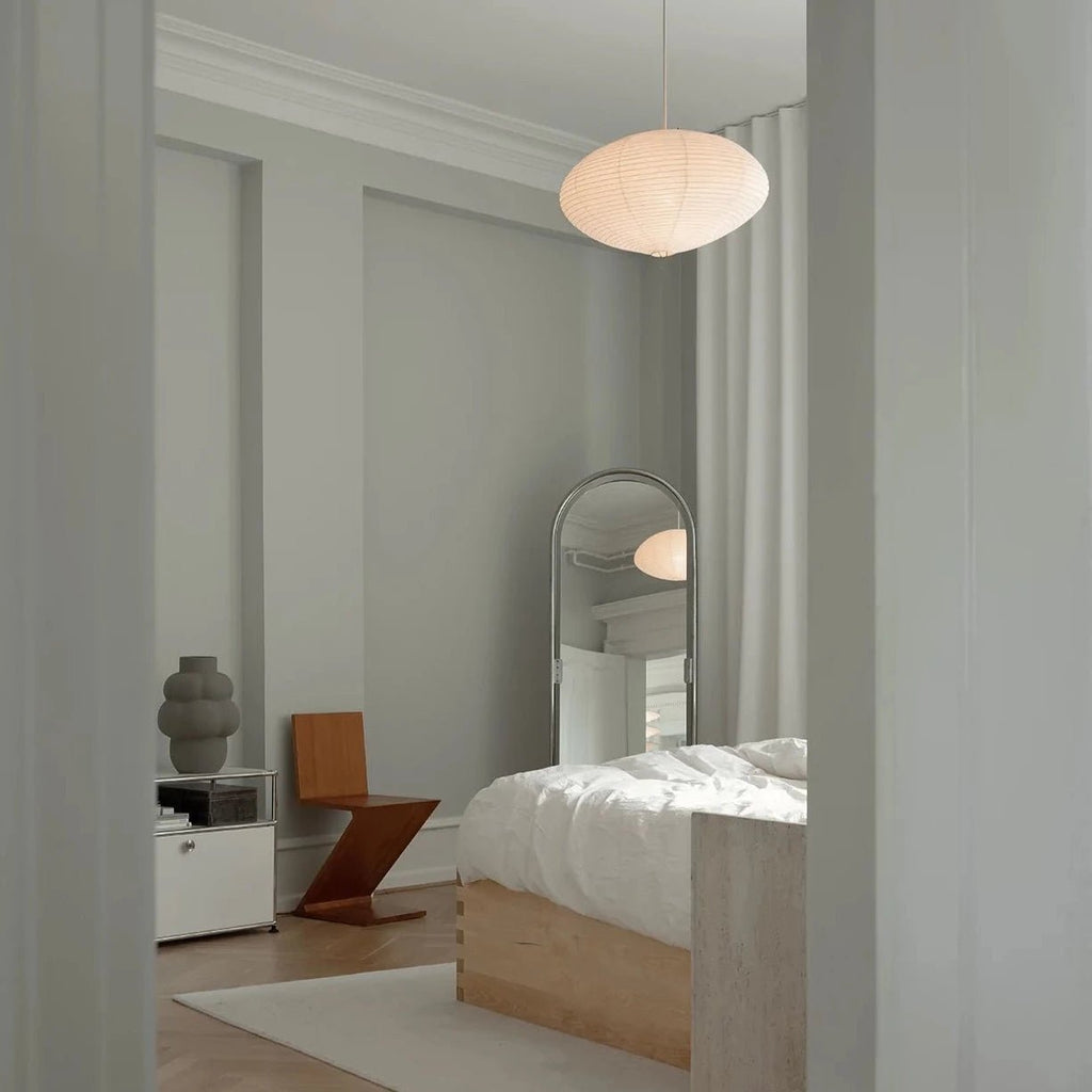 A bedroom with a LOUISE ROE CERAMIC BALLOON VASE 04 GRANDE bed and mirror designed in a Gestalt Haus style.