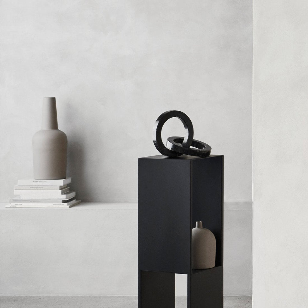 A black Gestalt Haus stand with two DOME VASES and a DOME VASE.