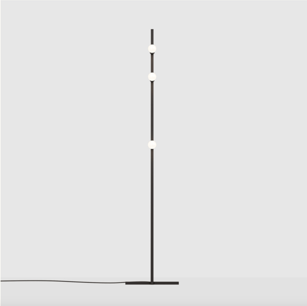 A DOT LINE FLOOR LAMP with a black base and a white light bulb by LAMBERT ET FILS.