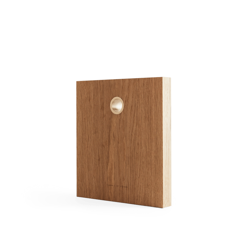 A FRAMA wooden box with a hole in the middle, made from DRY STUDIOS OAK CUTTING BOARDS.