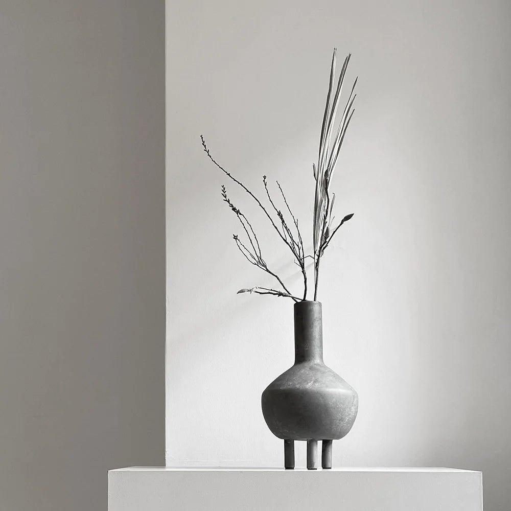 A black and white photo of a 101 COPENHAGEN DUCK VASE on a table at Gestalt Haus.