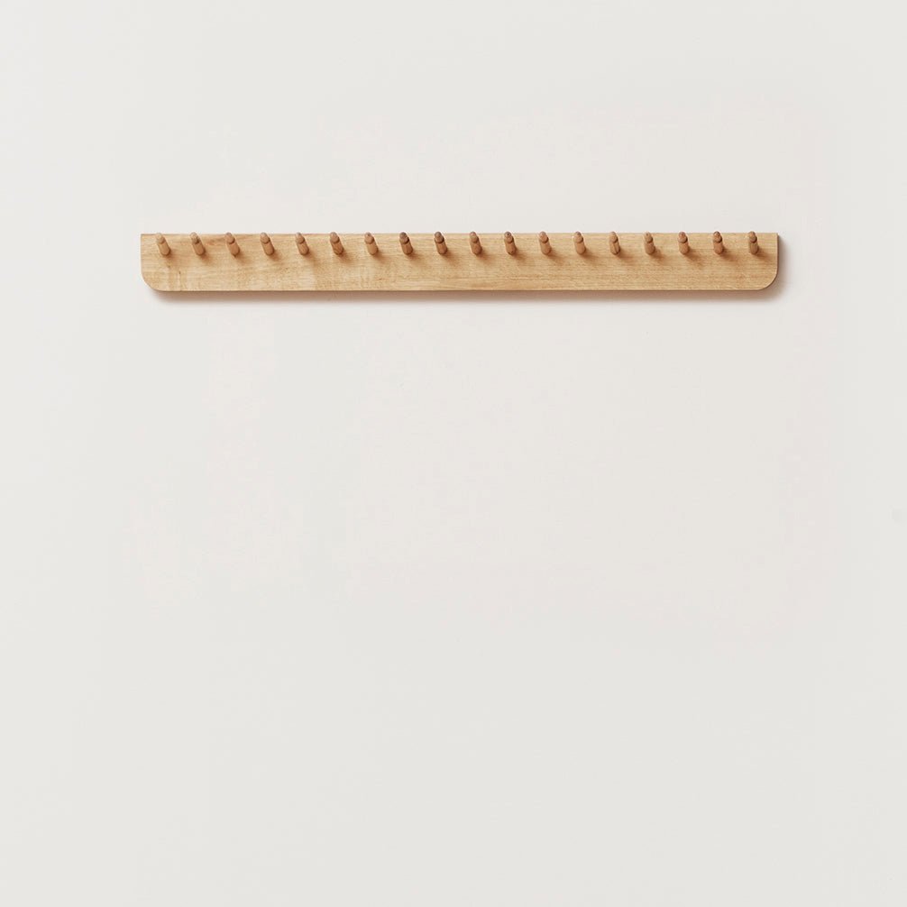 An ECHO COAT RACK 88 by FORM & REFINE hanging on a Gestalt Haus wall.