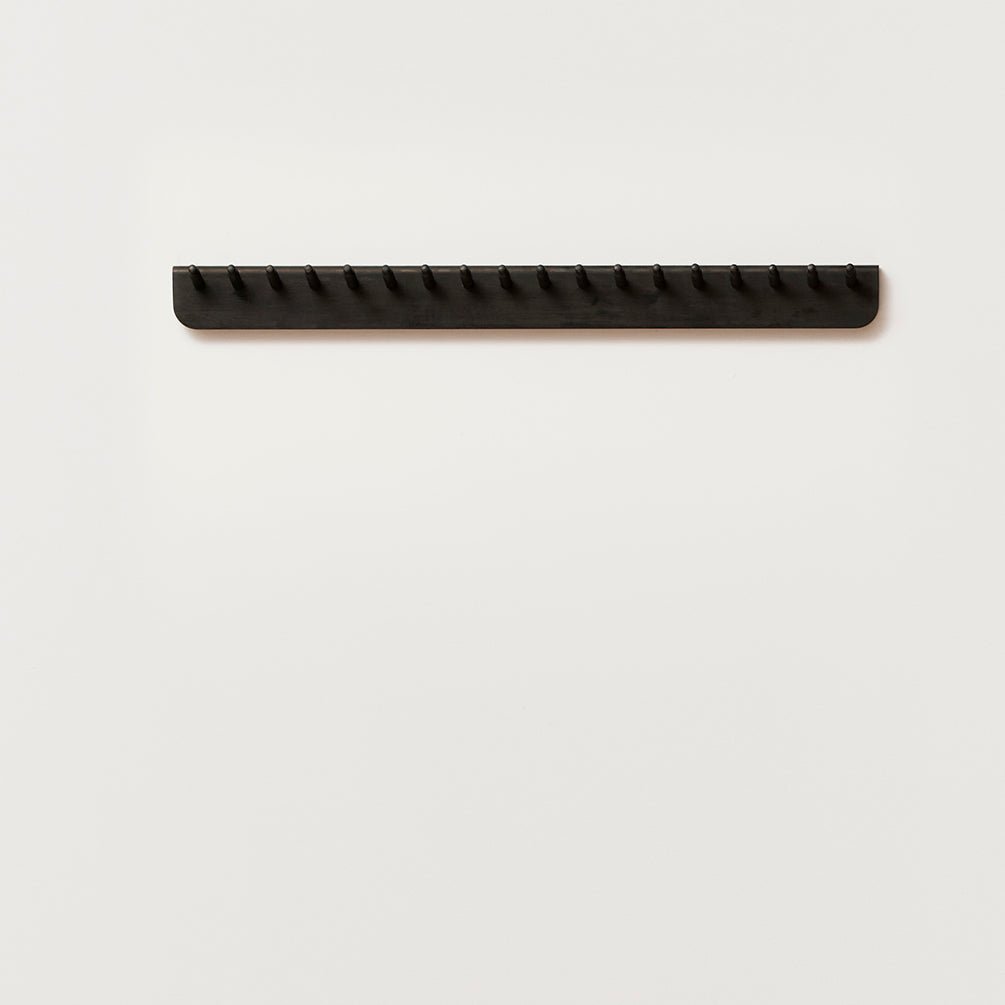 A FORM & REFINE ECHO COAT RACK 88 hanging on a white wall at Gestalt Haus.