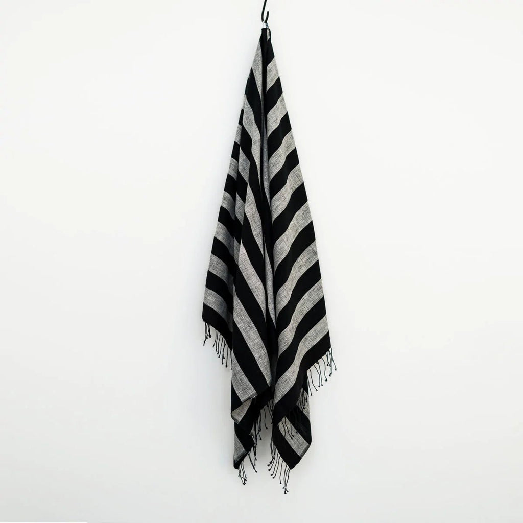 A towel from the SERA HELSINKI HAND WOVEN TOWEL COLLECTION displayed on a wall at Gestalt Haus.