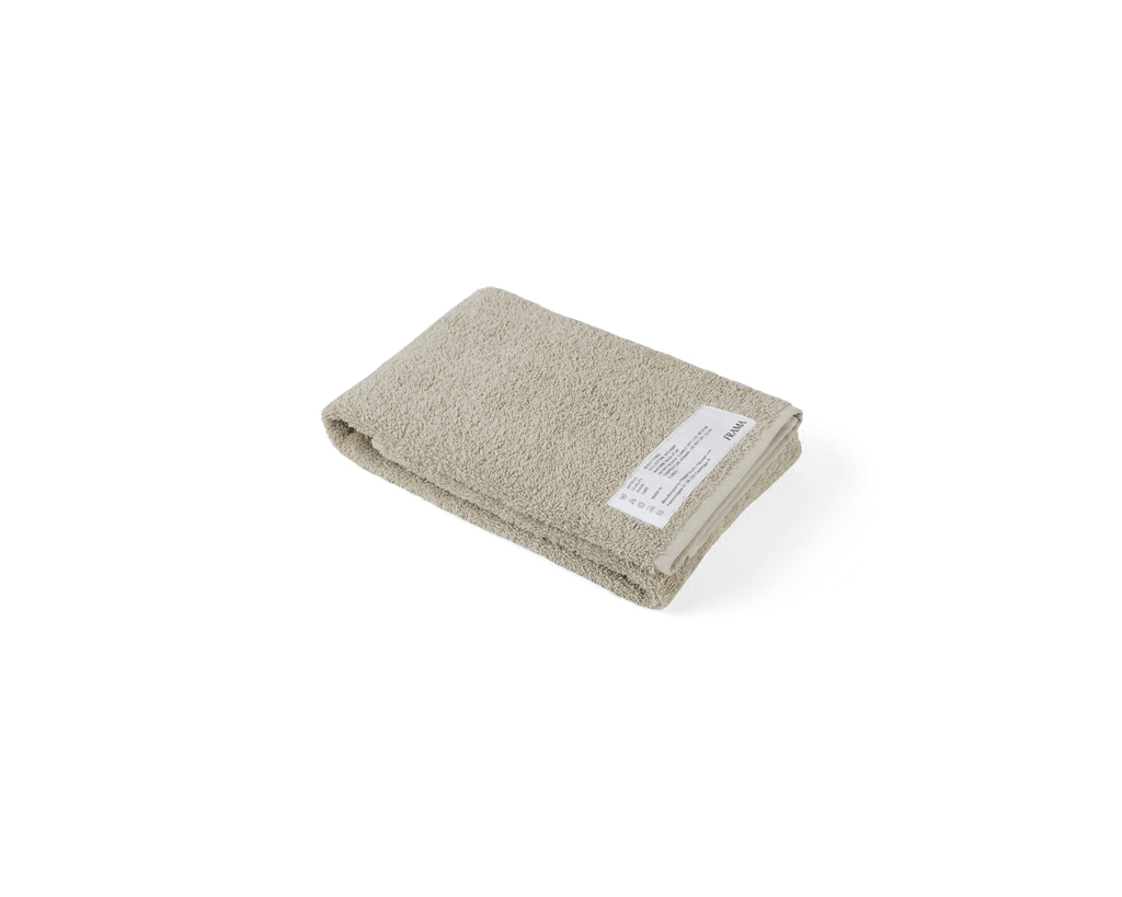 A beige HEAVY TOWELS BY FRAMA on a white background at Gestalt Haus.