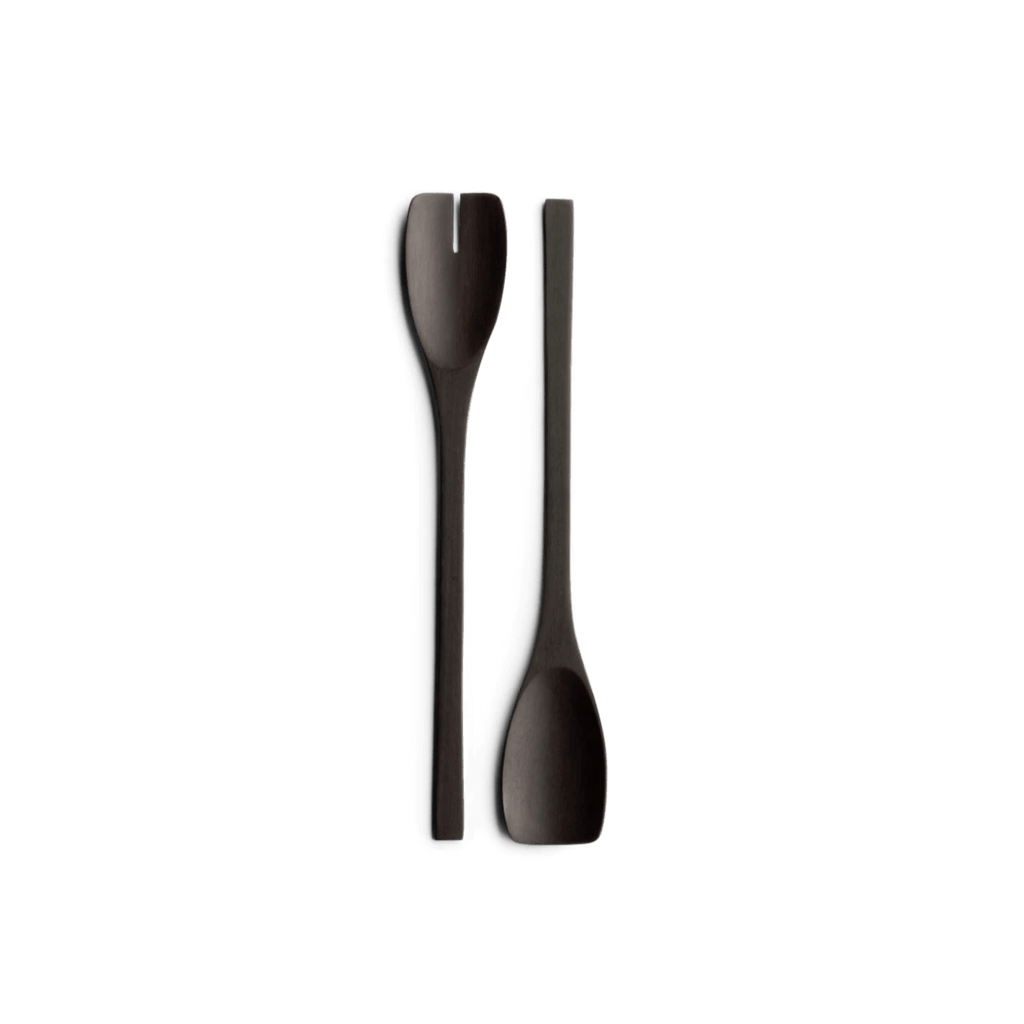 Two JOHN PAWSON SALAD SERVERS by WHEN OBJECTS WORK on a black background, showcasing the elegant design of Gestalt Haus.