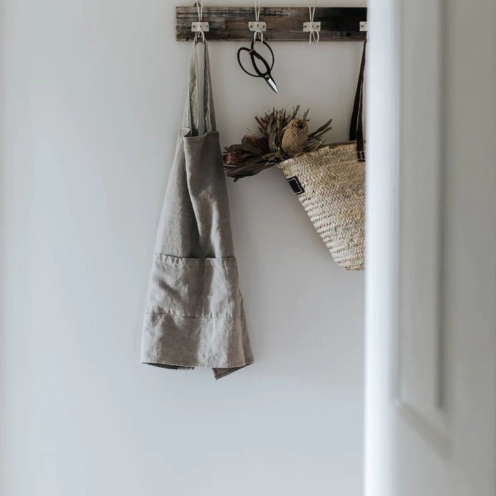 A CULTIVER apron made of JUDE linen hanging in a kitchen.