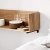 A bed with a Kristina Dam Studio STACK WALL SHELF featuring glasses on it at Gestalt Haus.