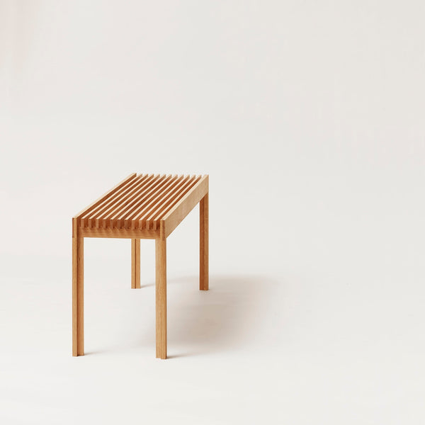 A lightweight bench by FORM & REFINE displayed on a white background.