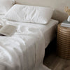 A CULTIVER bed with LINEN SHEET SET and PILLOWCASES.