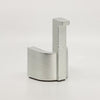 A LUG DOORSTOP by LAKER STUDIO, a small piece of metal, sitting on a white surface.