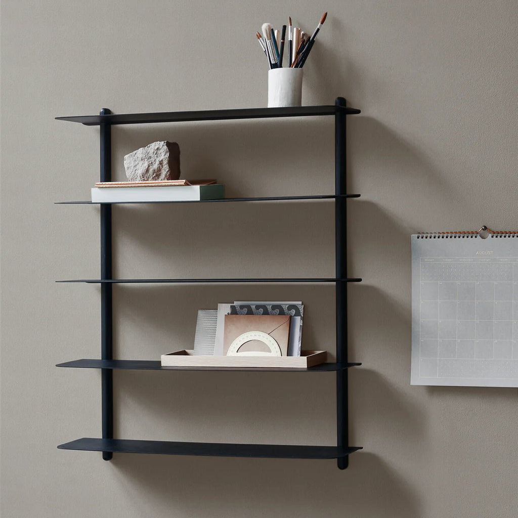 A black NIVO SHELF E with shelves and a clock on it, designed by GEJST in the style of Gestalt Haus.