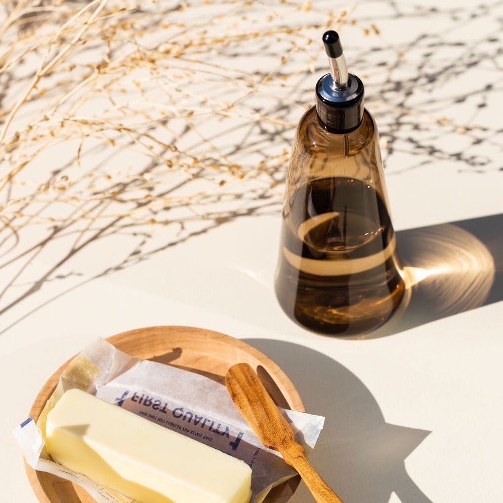 A GARY BODKER DESIGNS OLIVE OIL CRUET and a wooden spoon on a plate at Gestalt Haus.