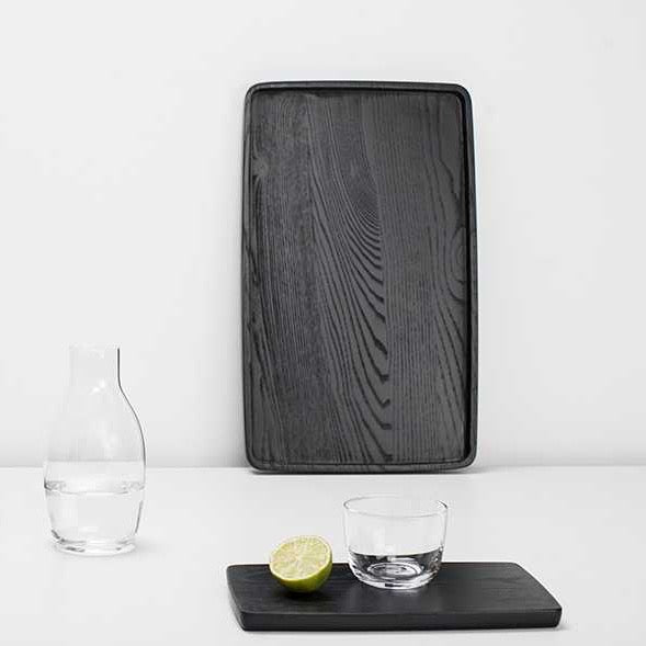 A Gestalt Haus tray by Vincent Van Duysen with a lime and a glass. (Brand: SERAX)