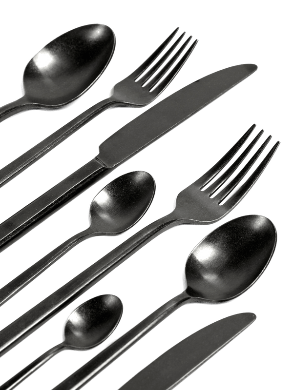 A set of PURE flatware knives, forks and spoons on a blue background by SERAX.