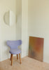 A Gestalt Haus chair in a room with a painting on the wall.