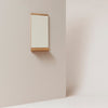 A FORM & REFINE RIM WALL MIRROR hanging in a white room at Gestalt Haus.