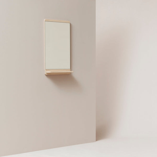 A FORM & REFINE RIM WALL MIRROR hanging on a wall in a white Gestalt Haus.