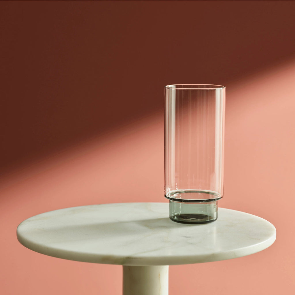 A RYE GLASSWARE COLLECTION vase from Gestalt Haus sits on top of an AARON PROBYN marble table.
