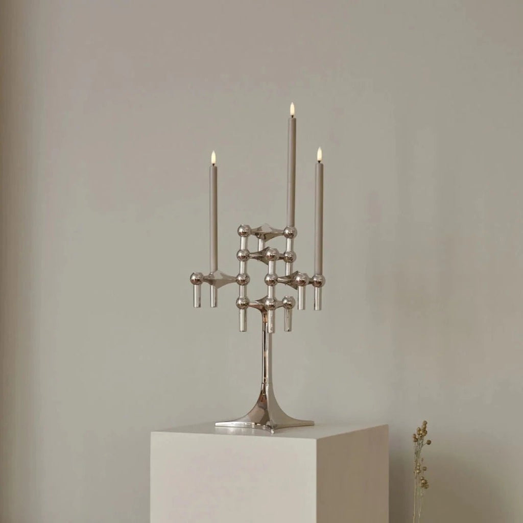 A STOFF NAGEL candle holder adorning a pedestal in the stylish Gestalt Haus.