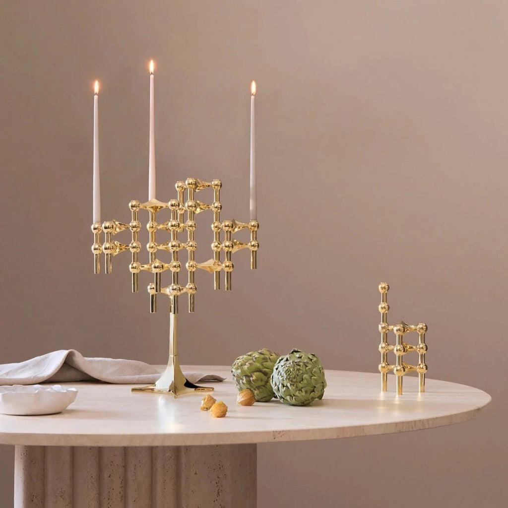 A STOFF NAGEL gold candle holder adorns a table at Gestalt Haus.
