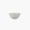 A white bowl on a black background from KLASSIK STUDIO, inspired by Gestalt principles.