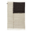 A monochrome E-1027 Rug with fringes by SERA HELSINKI, inspired by Gestalt Haus designs.