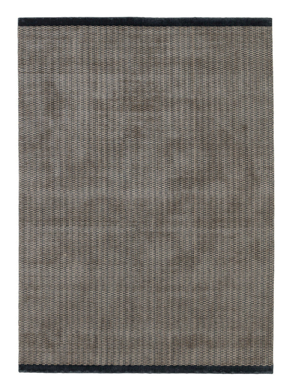 A grey Gestalt Haus rug with black trim on a white background, by FABULA LIVING.