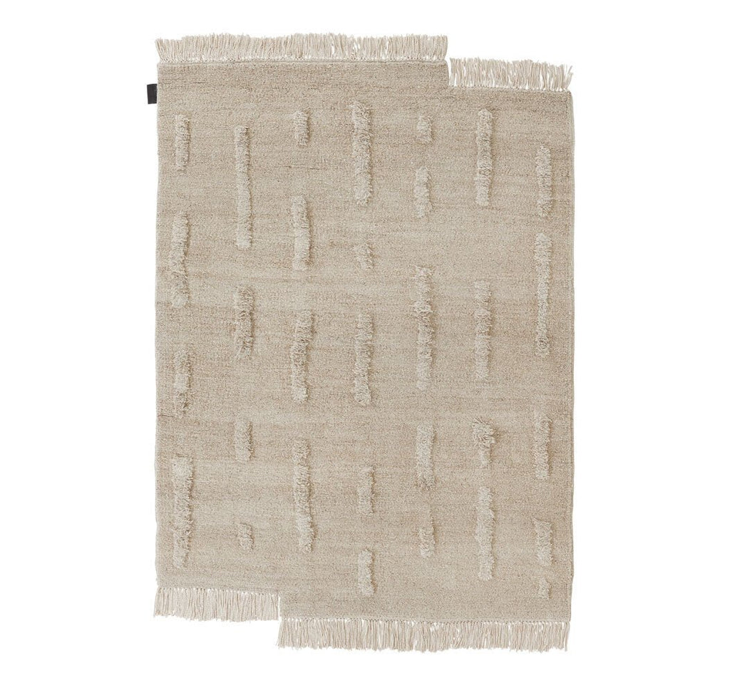 A THE LAINE RUG with fringes on a white background by SERA HELSINKI, featuring elements of Gestalt design.