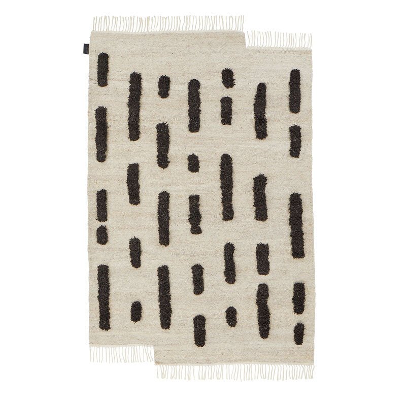 A THE LAINE RUG from SERA HELSINKI featuring black and white stripes in a Gestalt Haus design.