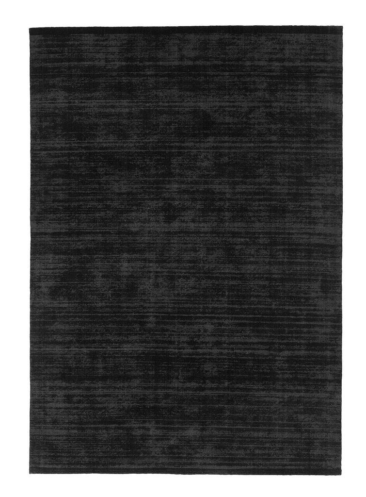 A black rug on a white background by FABULA LIVING.