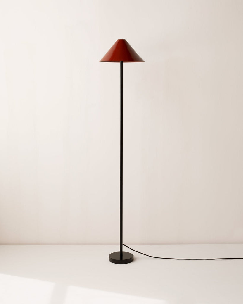 An Eave floor lamp by In Common With with a black base.