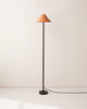 An orange shade and a black base IN COMMON WITH EAVE FLOOR LAMP.
